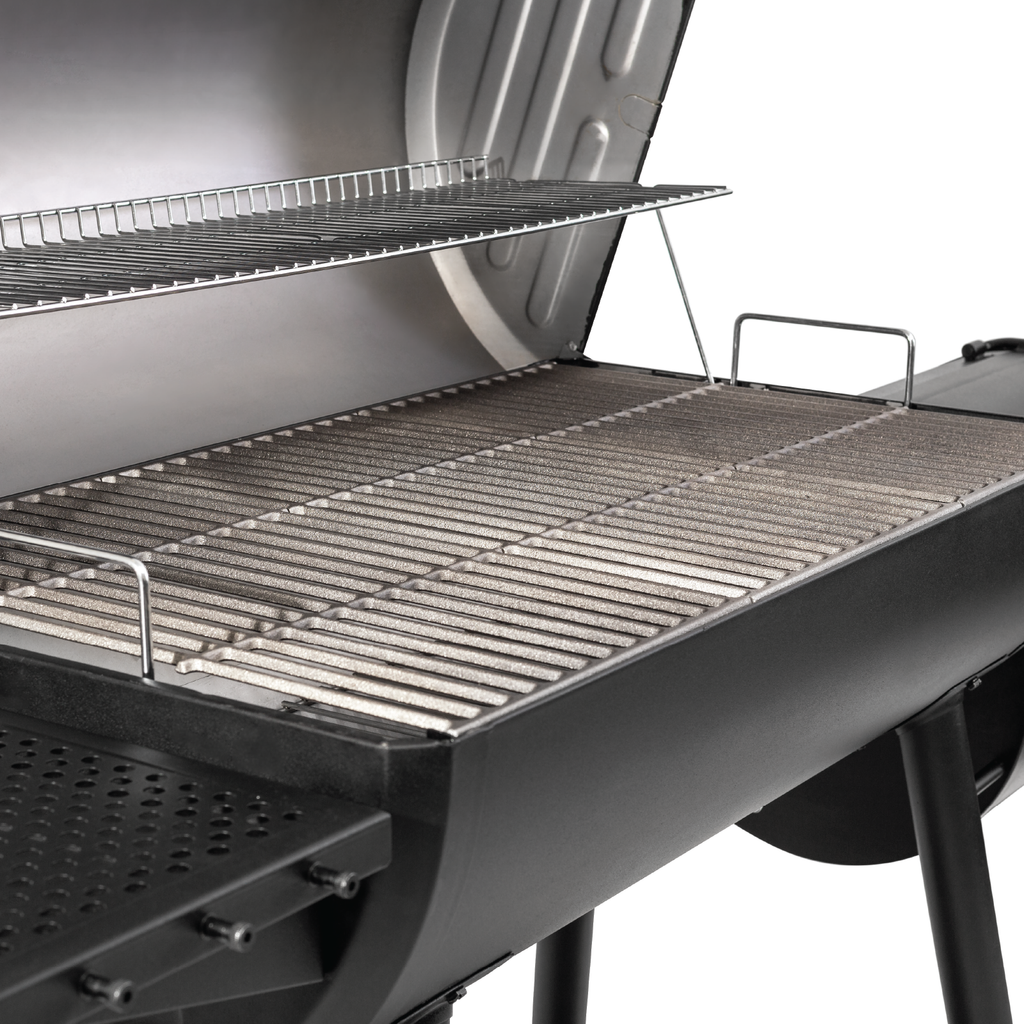 The barrel grill open to show the porcelain-coated cooking grate and the chrome plated warming rack above it.