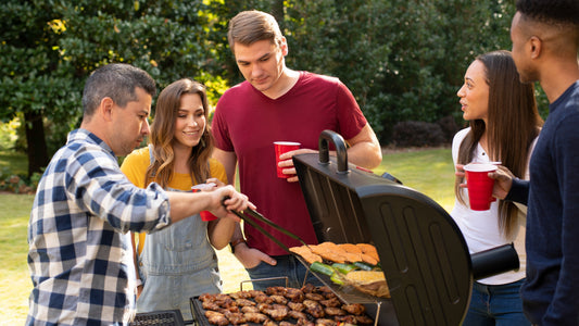 Group of people around a charcoal grill