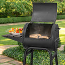 4 sausages cook in an open Patio Pro grill. A platter of vegetable skewers sits on the side shelf.