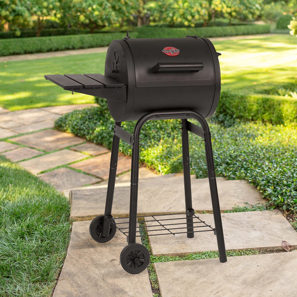 Patio Pro barrel grill on a stone paver walkway in a large, landscaped greenspace