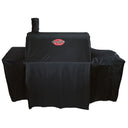 The cover installed on a barrel grill and offset smoker. Cover includes room for a side shelf on the left, the side fire box on the right, and one chimney in the left rear of the grill barrel.