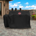 Covered grill without a side fire box outside on a brick patio.