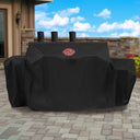 Covered grill with a side fire box outside on a brick patio.