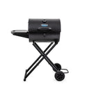 Black portable Gambler grill on collapsible wheeled cart.