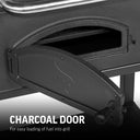 Closeup of the charcoal door mounted in the front of the grill body. Text reads: Charcoal door for easy loading of fuel into the grill.