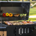 An open classic grill filled with meat, fish, and vegetables.