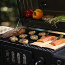 Another view of the classic grill with a variety of food cooking in it.