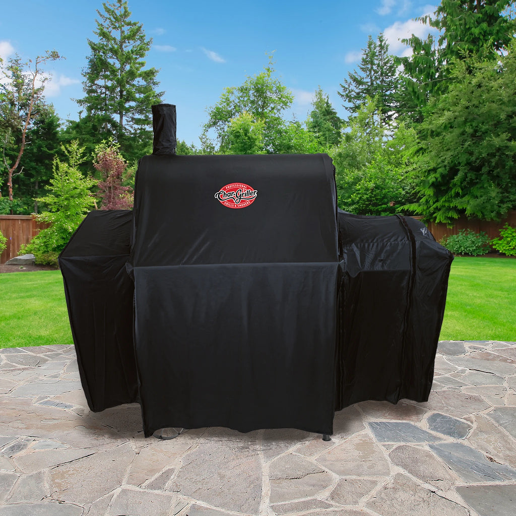 Covered Pro Deluxe grill with side fire box sitting on  an outdoor patio.
