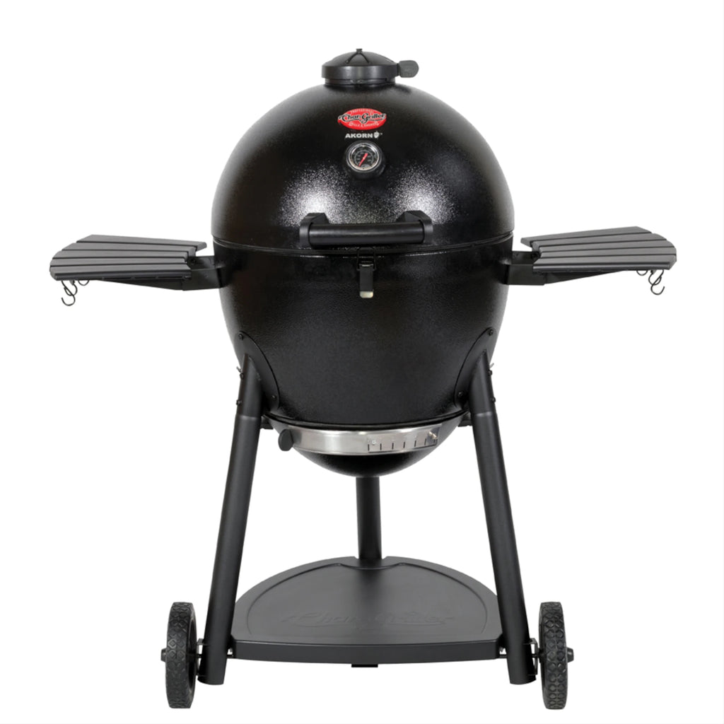 Black AKORN Kamado Grill on wheeled cart with side shelves raised. Seen from the front against a white background. The cart has wheels and a shelf.