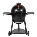 Black AKORN Kamado Grill on wheeled cart with side shelves raised. Seen from the front against a white background. The cart has wheels and a shelf.