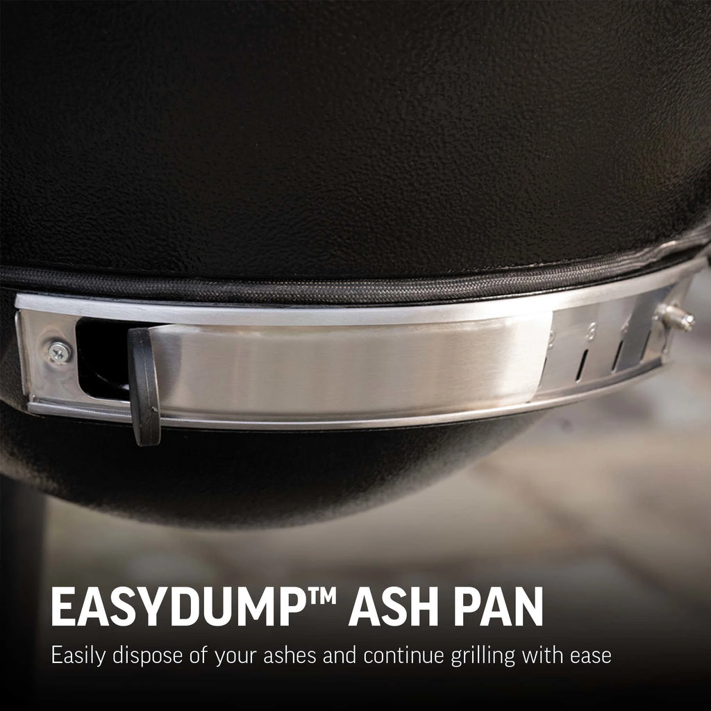 Closeup of the EasyDump ash pan mounted at the bottom of the grill body. Ash pash also has a sliding adjustable damper, partially open here. Text reads: EasyDump ash pan. Easily dispose of your ashes and continue grilling with ease.