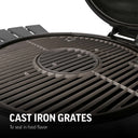 Closeup of the circular grill grates in the grill. There is a small round grate in the center than can be removed to add charcoal to the fire. Text reads: cast iron grates to seal in food flavor.