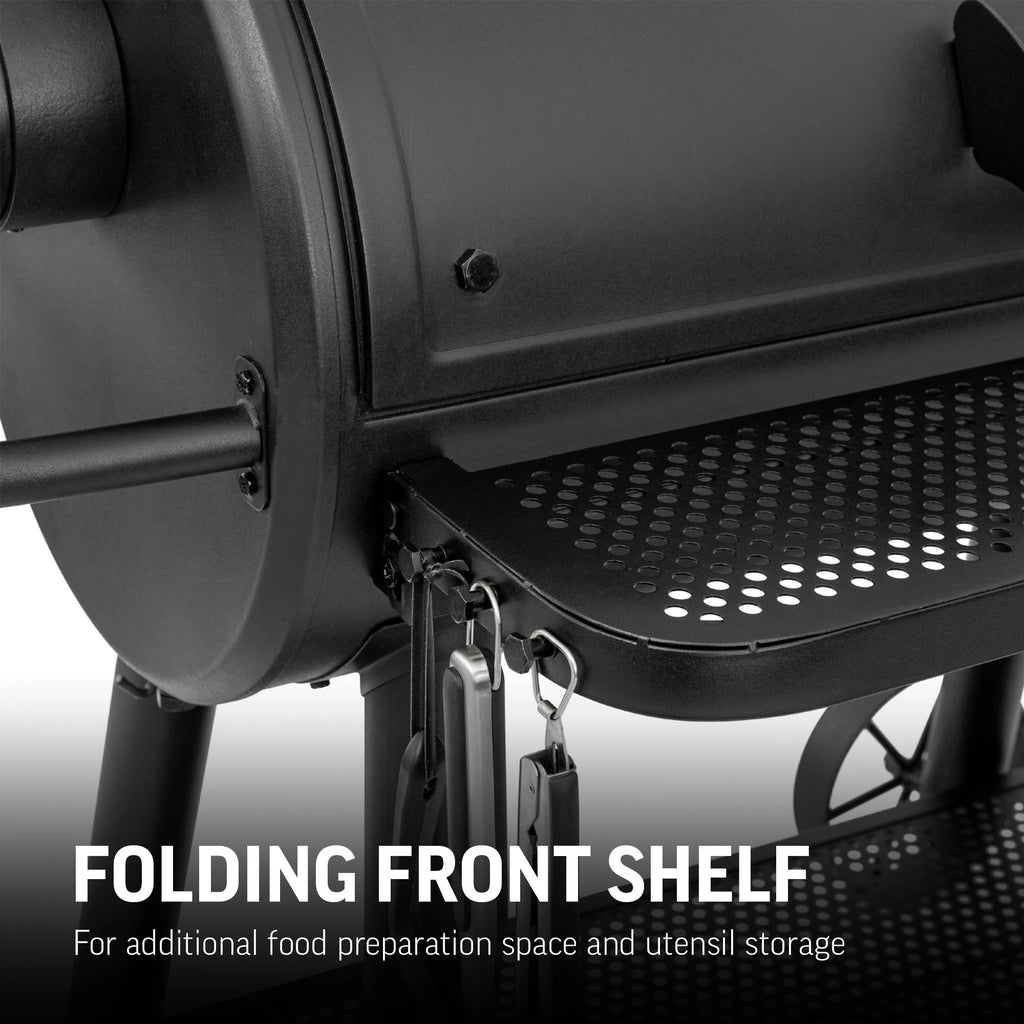 Closeup of the left end of the perforated metal folding front  shelf. The front corner of the shelf is curved. There are 3 utensil hooks build into the left side of the shelf, and the tops of 3 utensils hanging from them are just visible. Text reads: Folding front shelf for additional food preparation space and utensil storage.