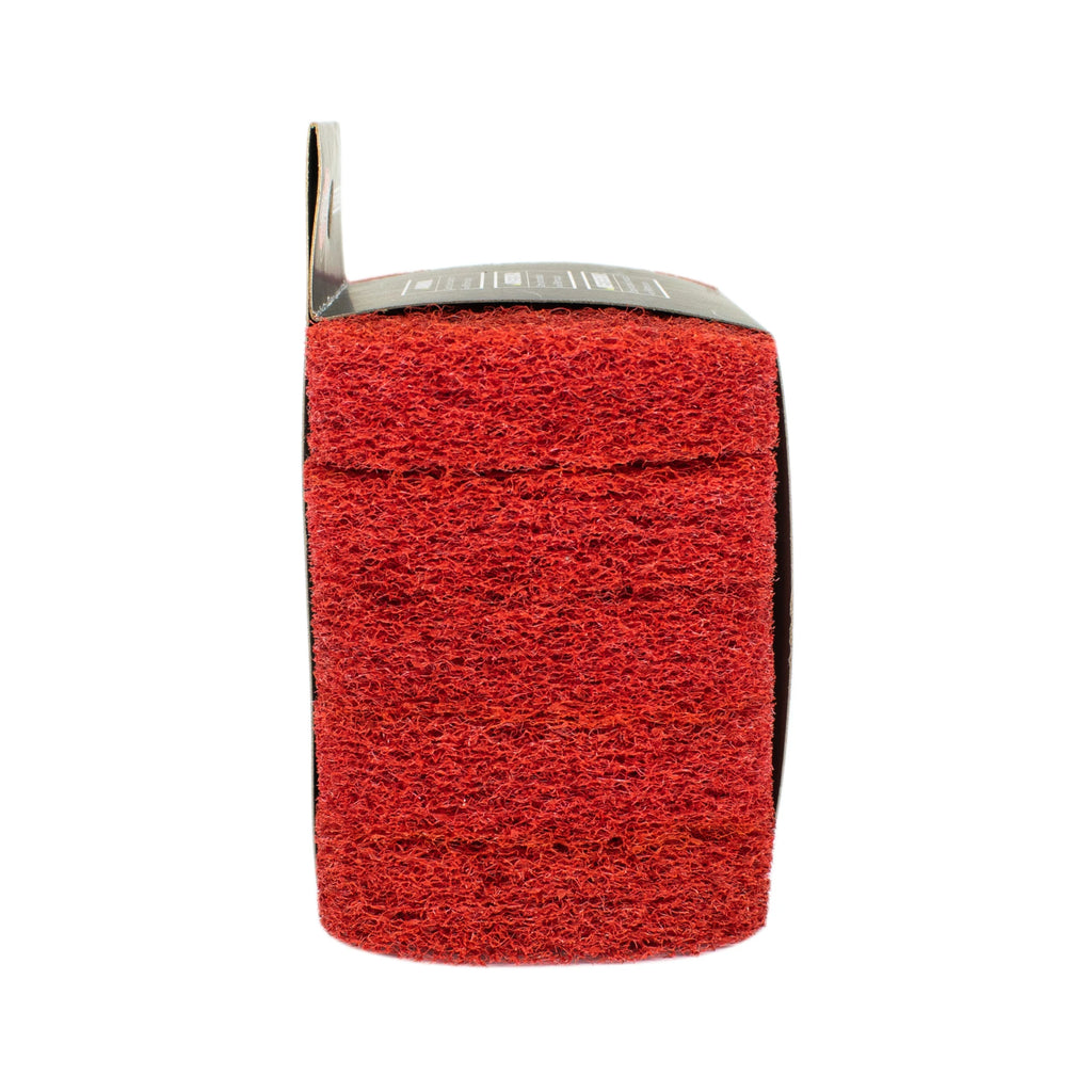 Stack of 5 scouring pads wrapped in retail packaging, seen from the side to show short ends of the stacked pads.