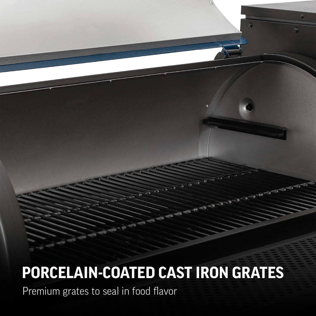 Porcelain-coated cast iron grates inside a Gravity Fed 980 grill. Text overlay reads: Porcelain-coated cast iron grates. Premium grates to seal in the flavor.