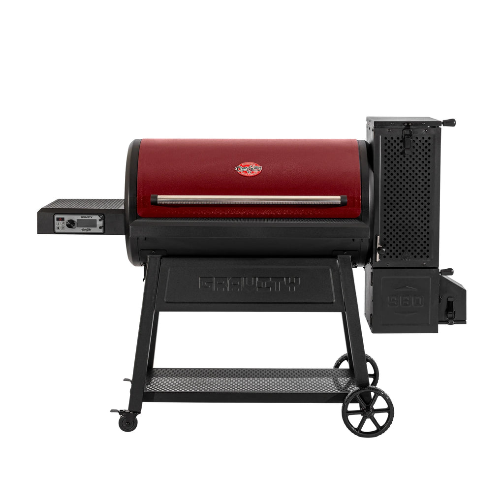 The Gravity Fed 980 barrel charcoal grill, in red, on a white background. The barrel lid is red. The charcoal hopper, cart, and left side shelf are black.