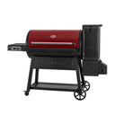 Angled view of the Gravity Fed 980 grill. This view shows more of the charcoal hopper and large wheel on the cart.