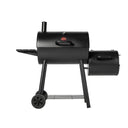 The Smokin' Pro barrel grill with offset smoker firebox mounted on the right side and a utility shelf mounted on the left. The grill has one chimney on the left of the barrel grill top. The grill is mounted on a cart with 2 wheels and a wire shelf mounted between the legs just above the wheels.
