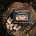 Box of Char-Griller fire starters on a wooden log outdoors