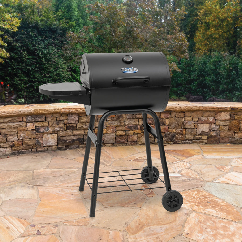 King-Griller Gambler grill on a stone patio with trees in the background