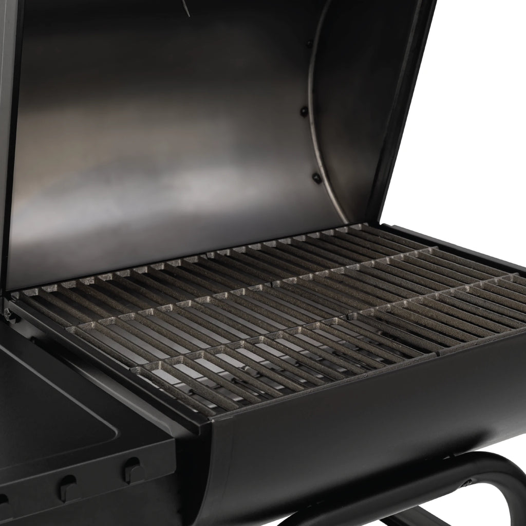 Cast iron grates inside an open Gambler charcoal grill