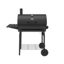 Black barrel grill on a cart with a side shelf on the left and a narrow shelf across the front. The grill is on a cart with 2 wheels and a wire shelf near the bottom. The grill lid has a smokestack on the left, built-in temperature gauge, and handle.