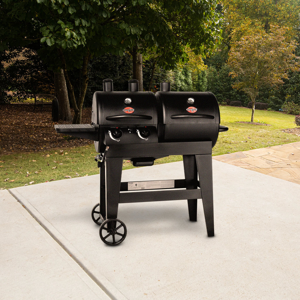 A Dual Threat grill sits outside on a concrete patio.