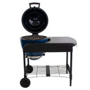 The Akorn grill mounted in the cart with the grill hood open to show the cast iron cooking grates.