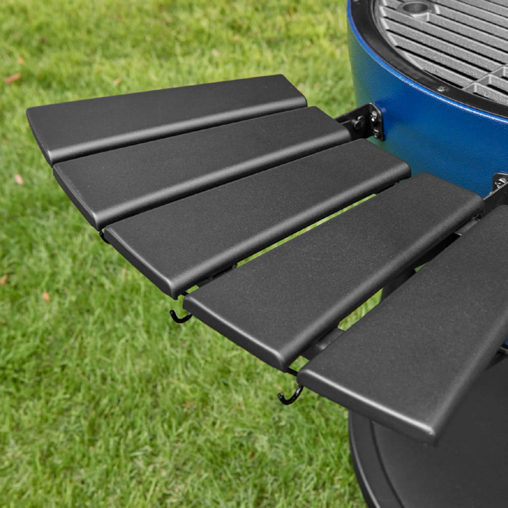 Close-up of the black side shelf mounted on a sapphire AKORN grill