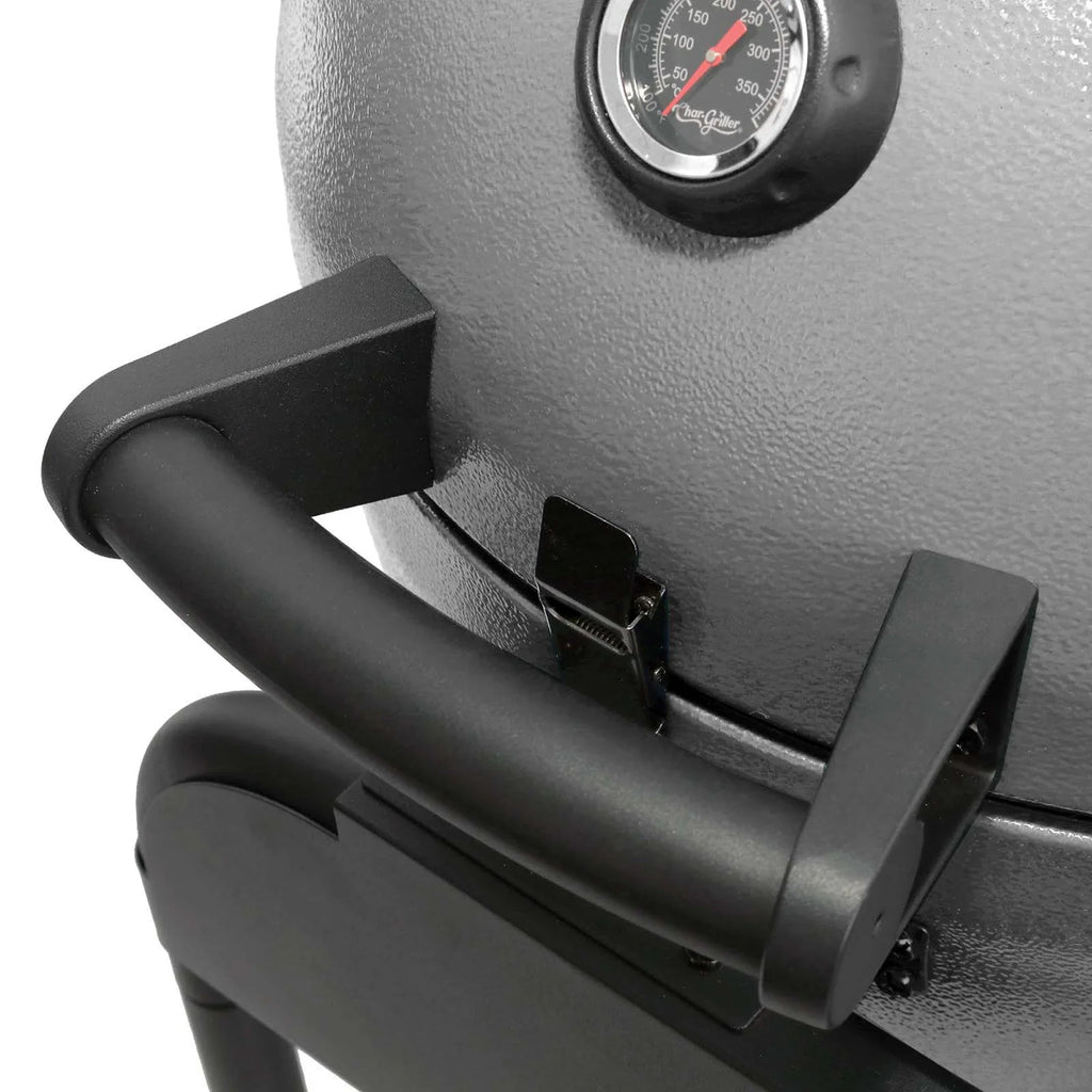 Close-up of the grill lid with a black handle, latch, and temperature gauge on a white background.