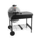 A ash grey Akorn kamado grill in  a cart with a black side table and wheels, shown on a solid white background.