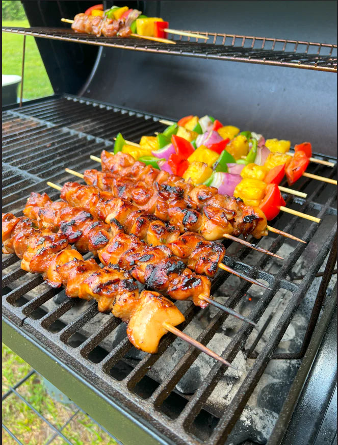 Grilled skewers with chicken and vegetables on a barbecue grill