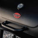 The lid of the barrel grill with a handle, built-in temperature gauge, and the Char-Griller logo plate.
