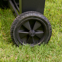 Close-up of a cart wheel. The wheel hub is solid black plastic. 