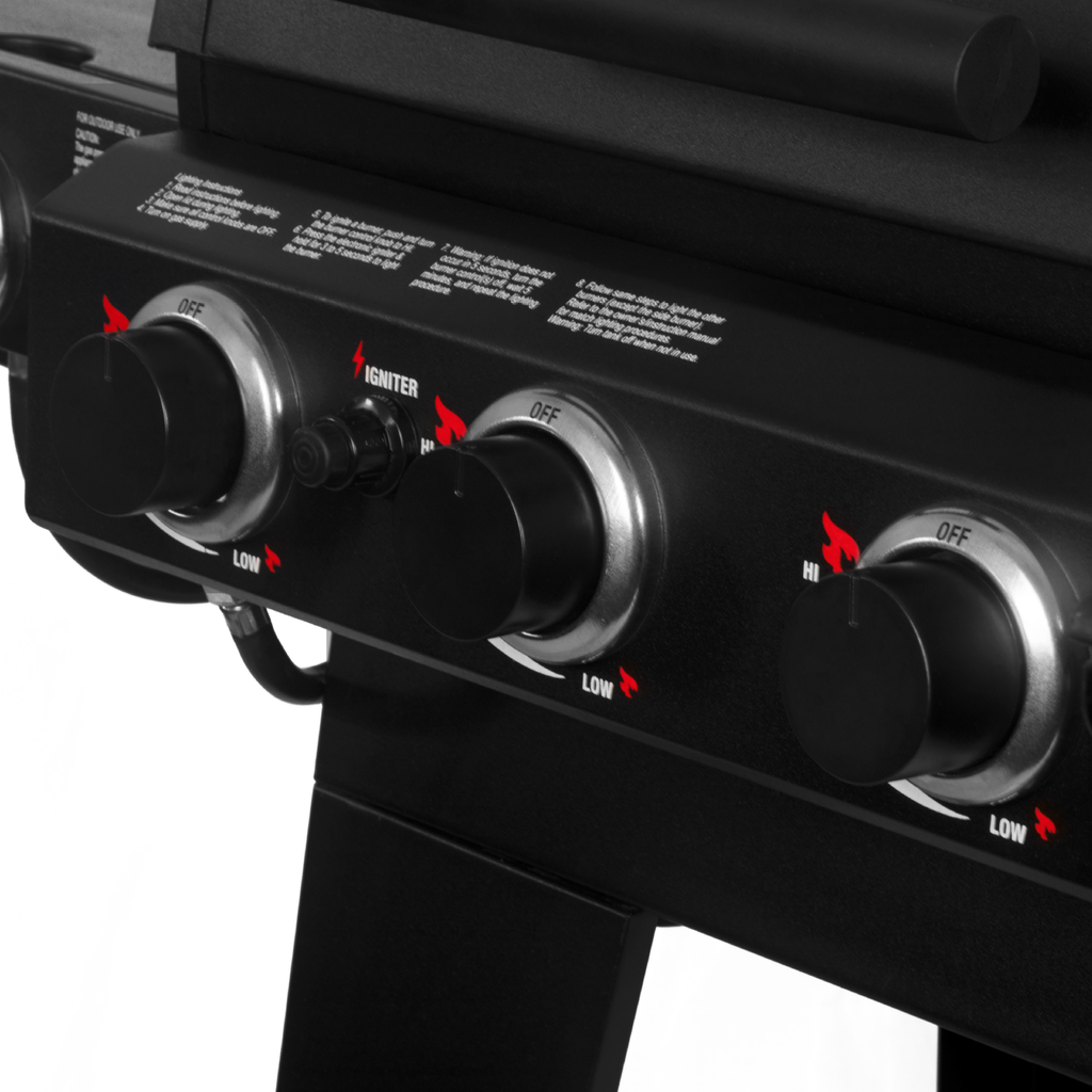 A close-up of the 3 burner knobs on the gas side of the grill. There is also a push-button ignitor on the control panel.